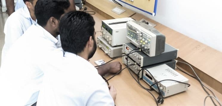 Electronics laboratory with students working